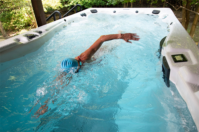 Meredith Kessler, IRONMAN® champion, with an h2x swim spa by master spas