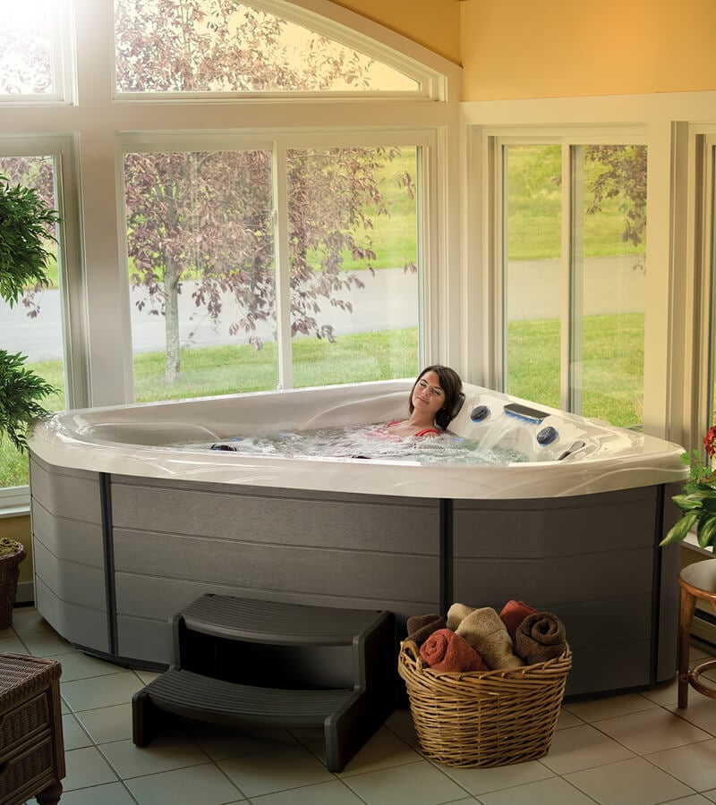A corner two-person hot tub completes this sunroom design