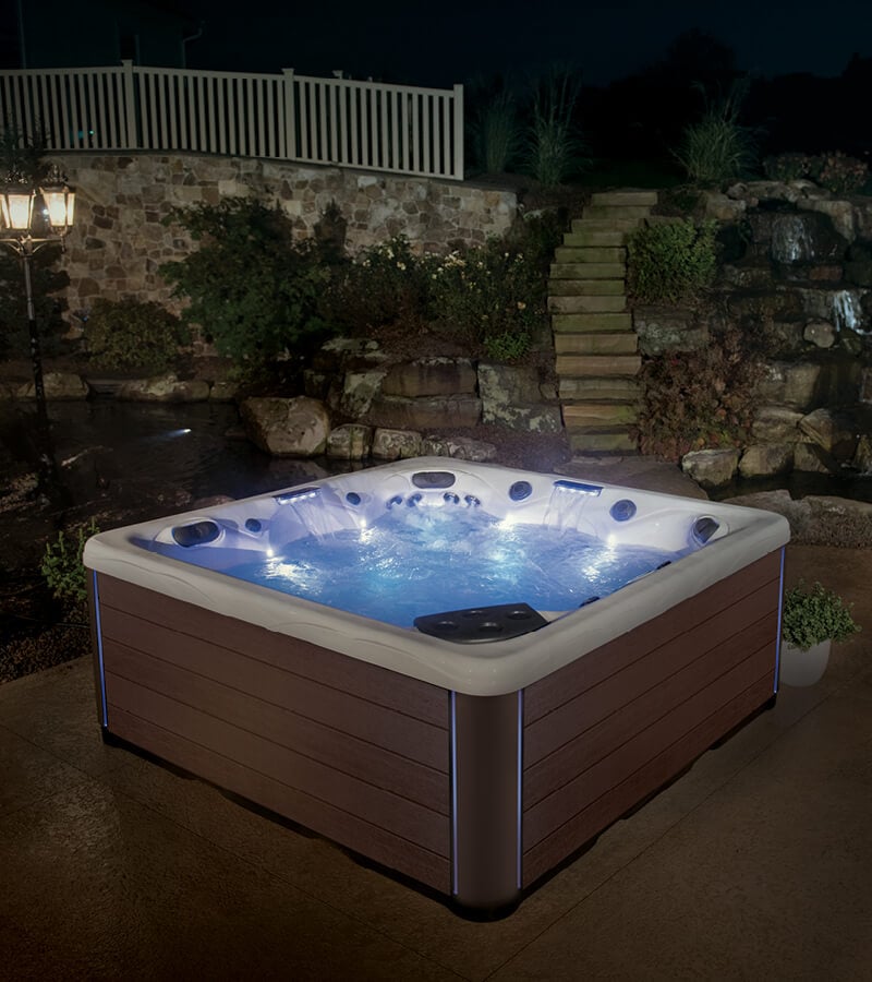 Colorful LED lights on the hot tub add ambiance to the backyard patio